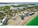An amazing aerial view showcases the buildings adjacent to the sandy beach and aqua waters at 2729 North Beach Rd # 212, Englewood, FL 34223