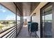 Spacious screened condo balcony with bar seating, offering serene views of the tropical landscape and waterway at 2729 North Beach Rd # 212, Englewood, FL 34223