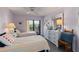 Bright bedroom with two twin beds and access to the balcony at 2729 North Beach Rd # 212, Englewood, FL 34223