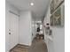 Bright hallway with tasteful seashell decorations that leads into the dining and living area with neutral décor at 2729 North Beach Rd # 212, Englewood, FL 34223