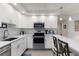 Charming kitchen with stainless steel appliances, stone countertops, and pendant lighting over the breakfast bar seating at 2729 North Beach Rd # 212, Englewood, FL 34223