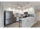 Bright kitchen offering stainless steel appliances, shaker cabinets, and a breakfast bar with contemporary pendant lighting at 2729 North Beach Rd # 212, Englewood, FL 34223