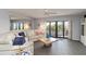 Comfortable living room with neutral tones, balcony view, and stylish decor at 2729 North Beach Rd # 212, Englewood, FL 34223