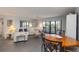 Inviting living room with balcony access, gray tile floors, and ample seating area at 2729 North Beach Rd # 212, Englewood, FL 34223