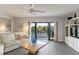 Cozy living room with balcony access and a ceiling fan at 2729 North Beach Rd # 212, Englewood, FL 34223