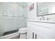 Elegant bathroom featuring a glass shower, modern vanity, and black hardware at 3016 Gulf Dr, Holmes Beach, FL 34217