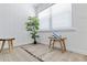 Bright bedroom features a large window, decorative plant, accent table, and wood-look flooring at 3016 Gulf Dr, Holmes Beach, FL 34217