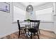 Bright dining area with modern black chairs, white round table, and natural light at 3016 Gulf Dr, Holmes Beach, FL 34217