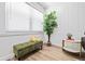 Cozy nook with a green bench, white shiplap walls, and a large window for natural light at 3016 Gulf Dr, Holmes Beach, FL 34217