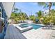 Beautiful pool and spa surrounded by lush palms offering a private retreat at 3016 Gulf Dr, Holmes Beach, FL 34217