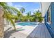 Relaxing pool and patio area with lush landscaping, perfect for outdoor entertaining at 3016 Gulf Dr, Holmes Beach, FL 34217