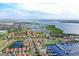 Aerial view of a beautiful coastal community with waterfront homes, boat docks, and vibrant landscaping near a bay at 303 9Th E Ave, Palmetto, FL 34221