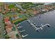 Aerial view of a residential community with boat docks, tennis courts, a swimming pool, and lush landscaping at 303 9Th E Ave, Palmetto, FL 34221