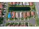 Aerial view of the community showcasing tile roofs, swimming pools, and lush landscaping, highlighting its appeal at 303 9Th E Ave, Palmetto, FL 34221