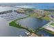 Aerial view of waterfront community featuring lush landscaping, marina, and multiple community pools at 303 9Th E Ave, Palmetto, FL 34221