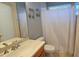 Bright bathroom featuring a vanity with a sink, toilet, bathtub with shower, neutral tile and charming decor at 303 9Th E Ave, Palmetto, FL 34221