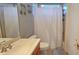 Bright bathroom featuring a vanity with a sink, toilet, bathtub with shower, neutral tile and charming decor at 303 9Th E Ave, Palmetto, FL 34221