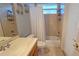 Bright bathroom featuring a vanity with a sink, toilet, bathtub with shower, neutral tile and charming decor at 303 9Th E Ave, Palmetto, FL 34221