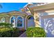 Charming home featuring manicured landscaping, an arched doorway, and a tile roof, perfect curb appeal at 303 9Th E Ave, Palmetto, FL 34221