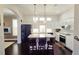 Modern kitchen with quartz counters, pendant lights, stainless appliances and hardwood floors at 303 9Th E Ave, Palmetto, FL 34221