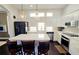 Bright kitchen features white cabinets, stainless steel appliances, pendant lighting, and a center island with seating at 303 9Th E Ave, Palmetto, FL 34221