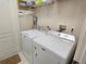 Well-equipped laundry room with a modern washer and dryer set, and overhead shelving for storage at 303 9Th E Ave, Palmetto, FL 34221