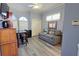 Living room with a ceiling fan, tv, work area, and comfortable seating at 303 9Th E Ave, Palmetto, FL 34221
