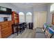 Living room has a ceiling fan, tv, work area, and a doorway to the bathroom at 303 9Th E Ave, Palmetto, FL 34221