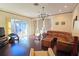 Open living room with hardwood floors, stylish lighting, and sliding glass doors leading to the outdoor area at 303 9Th E Ave, Palmetto, FL 34221