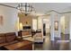 Spacious living room with hardwood floors, fireplace, modern lighting, and easy access to the kitchen at 303 9Th E Ave, Palmetto, FL 34221