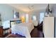 Comfortable main bedroom features a ceiling fan, TV, ample natural light and an en-suite bath at 303 9Th E Ave, Palmetto, FL 34221