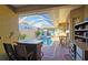 Covered backyard pool features a spa, an outdoor kitchen, and seating at 303 9Th E Ave, Palmetto, FL 34221