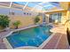 Enclosed patio with swimming pool and adjacent sunning chairs at 303 9Th E Ave, Palmetto, FL 34221