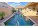 Private pool and spa are surrounded by mature landscaping and a screened enclosure at 303 9Th E Ave, Palmetto, FL 34221