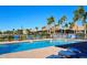 The community pool is the perfect place to cool off on a hot day, surrounded by palm trees and lounge chairs at 303 9Th E Ave, Palmetto, FL 34221