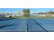 Enjoy a sunny match on this well-maintained tennis court with marina views and blue surface and white lines at 303 9Th E Ave, Palmetto, FL 34221