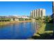 Scenic water view showcasing the home's waterfront location, with palm trees and nearby building at 303 9Th E Ave, Palmetto, FL 34221