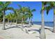 Scenic waterfront park view featuring palm trees, modern lounge chairs, and tranquil water views at 303 9Th E Ave, Palmetto, FL 34221