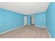 Bedroom with blue walls and neutral carpeting, offering a cozy and versatile space at 3072 Lake Bayshore Dr # 119, Bradenton, FL 34205