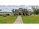 Attractive clubhouse with a well-kept lawn and palm trees at 3072 Lake Bayshore Dr # 119, Bradenton, FL 34205