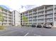 Exterior view of condominium complex featuring multiple floors and ample parking spaces at 3072 Lake Bayshore Dr # 119, Bradenton, FL 34205