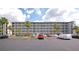 Exterior view of condominium complex featuring multiple floors and ample parking spaces at 3072 Lake Bayshore Dr # 119, Bradenton, FL 34205