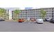 Exterior view of condominium complex featuring multiple floors and ample parking spaces at 3072 Lake Bayshore Dr # 119, Bradenton, FL 34205