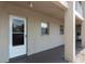 Exterior entrance featuring a secure white door and neutral colored walls with window accents at 3072 Lake Bayshore Dr # 119, Bradenton, FL 34205