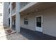 Building exterior featuring a door entrance and concrete walkway, offering easy access to the property at 3072 Lake Bayshore Dr # 119, Bradenton, FL 34205
