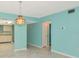 Open living area featuring pendant lighting and seamless flow into kitchen at 3072 Lake Bayshore Dr # 119, Bradenton, FL 34205