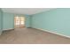 Inviting living room with neutral carpet and sliding glass doors to the screened lanai at 3072 Lake Bayshore Dr # 119, Bradenton, FL 34205