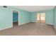 Cozy living room featuring neutral carpet and access to other rooms at 3072 Lake Bayshore Dr # 119, Bradenton, FL 34205