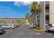 Wide shot of a well maintained parking lot and the complex under a bright blue sky at 3072 Lake Bayshore Dr # 119, Bradenton, FL 34205