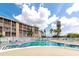 Inviting pool area with comfortable seating and partial building views at 3072 Lake Bayshore Dr # 119, Bradenton, FL 34205